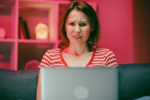 Sad Shocked Woman Reading News Online Laptop Home مجلة نقطة العلمية